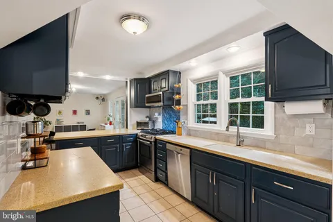 a kitchen with a sink stove and microwave