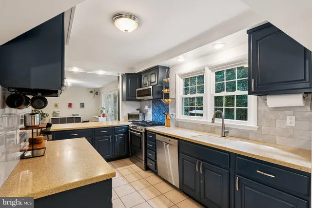 a kitchen with a sink stove and microwave