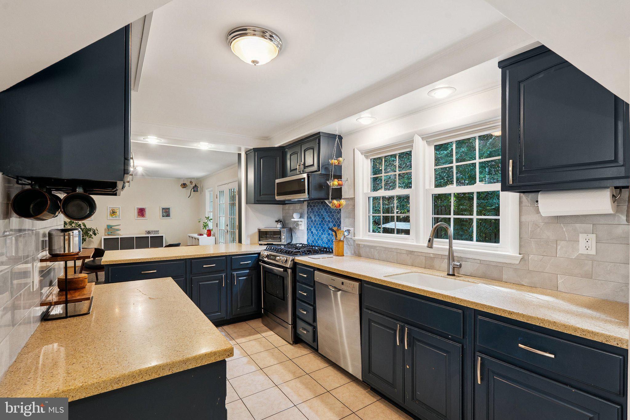 1432 Crestridge Drive Silver Spring, MD 20910 - Photo 43 of 52 a kitchen with a sink stove and microwave