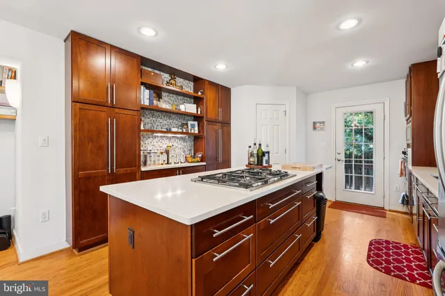 a kitchen with a stove and a wooden cabinets