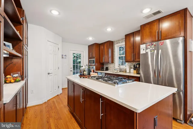 a kitchen with stainless steel appliances a sink and a refrigerator