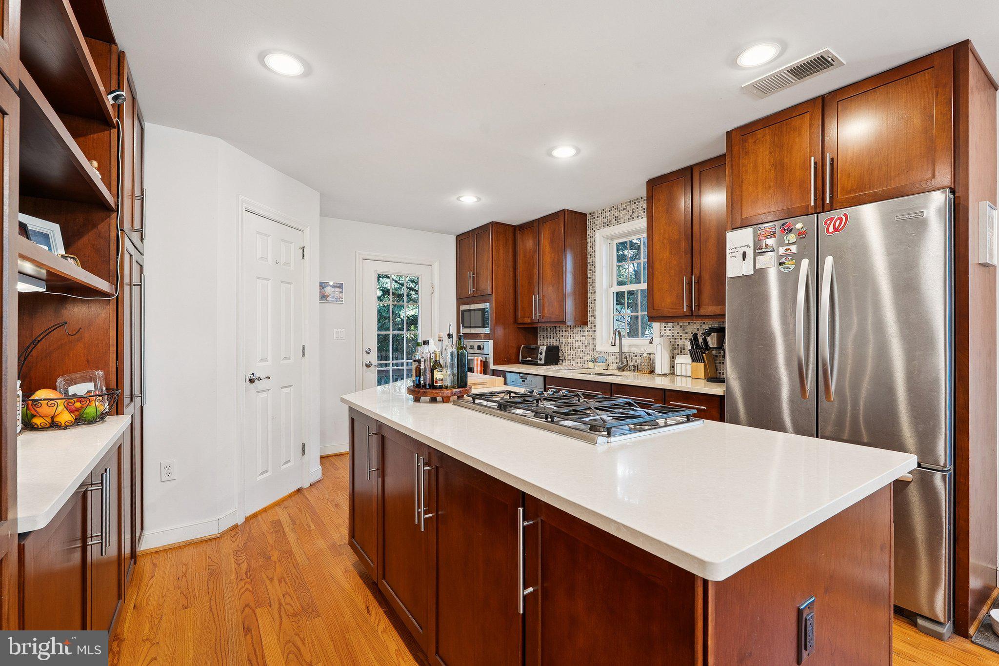 1432 Crestridge Drive Silver Spring, MD 20910 - Photo 7 of 52 a kitchen with stainless steel appliances a sink and a refrigerator