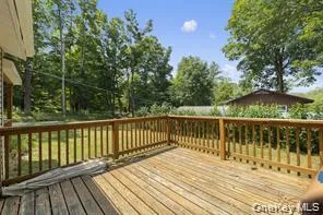 a view of balcony with wooden floor and fence