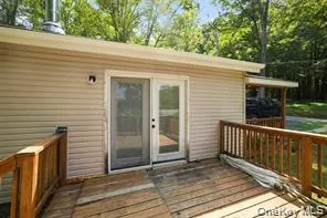 a view of a deck with wooden floor and fence and a yard