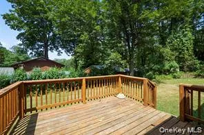 a balcony with wooden floor and outdoor space