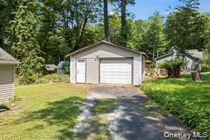 a view of a house with a yard and garage