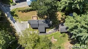 an aerial view of a house with swimming pool and garden space