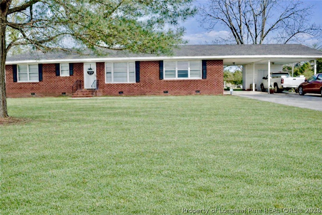 5309 Tobacco Road Orrum, NC 28369 - Photo 2 of 44 a front view of house with yard and outdoor seating