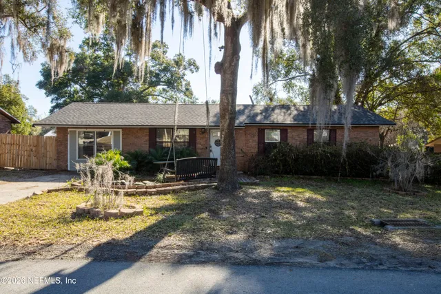 a view of a house with backyard porch and sitting area