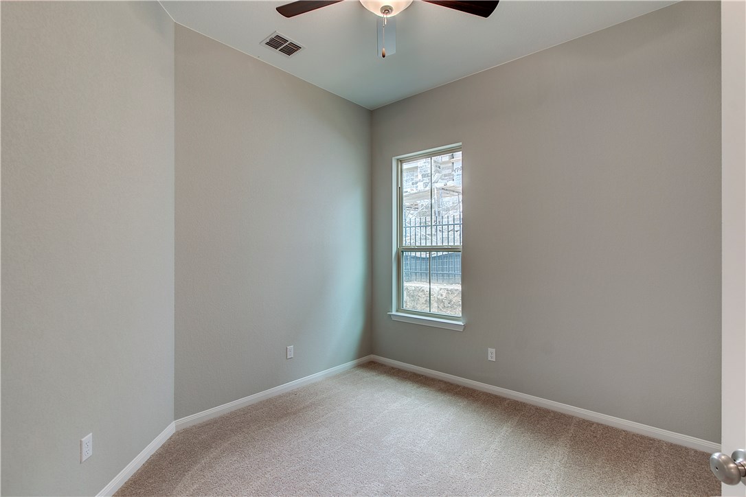 107 Cartwheel Bend Austin, TX 78738 - Photo 13 of 16 Empty room featuring a ceiling fan and light colored carpet
