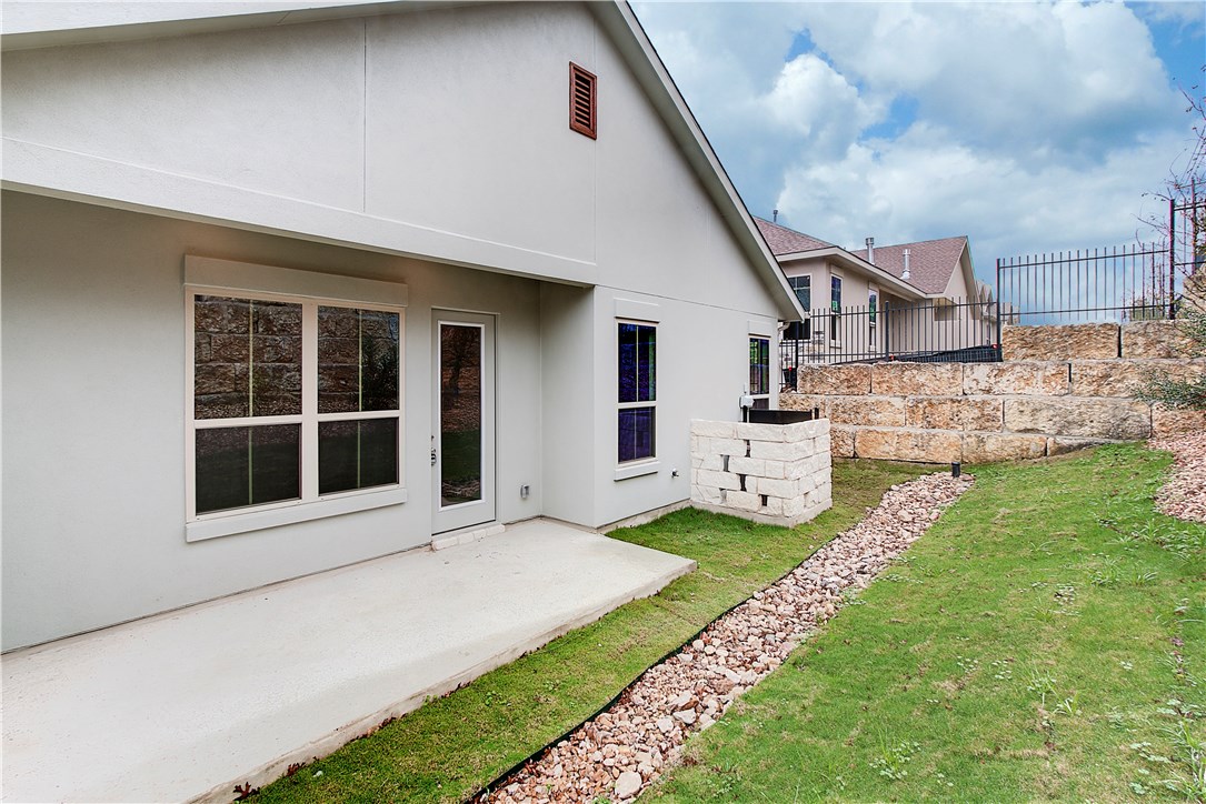 107 Cartwheel Bend Austin, TX 78738 - Photo 15 of 16 Back of house with a patio area and stucco siding