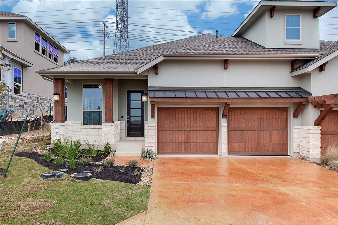 107 Cartwheel Bend Austin, TX 78738 - Photo 2 of 16 View of front of home with stucco siding, a garage, and covered porch