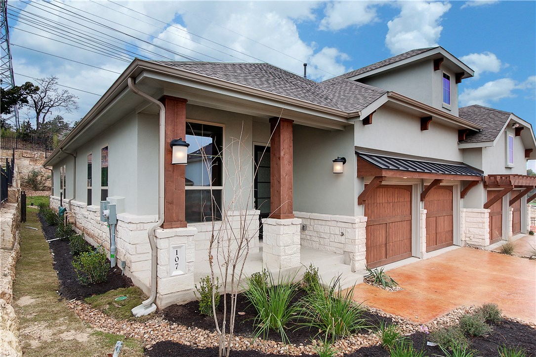 107 Cartwheel Bend Austin, TX 78738 - Photo 3 of 16 View of front of house with stucco siding, stone siding, a porch, and roof with shingles