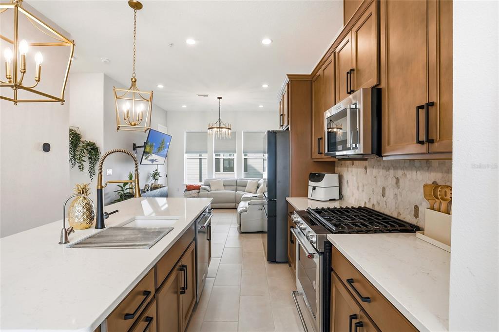 2038 Packing District Way Orlando, FL 32804 - Photo 11 of 39 a kitchen with a sink stove and cabinets