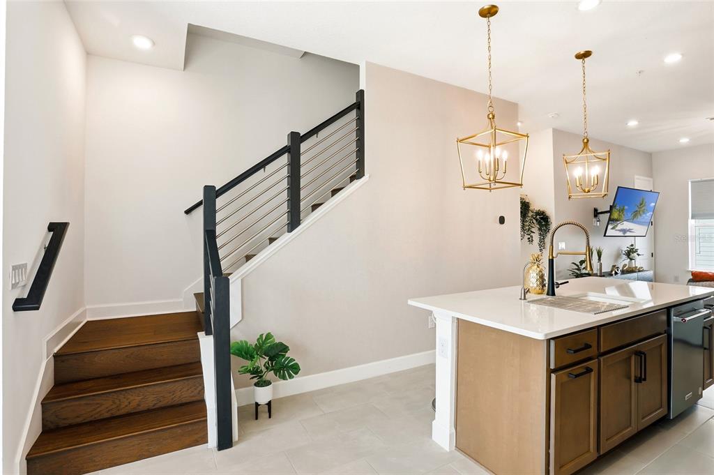 2038 Packing District Way Orlando, FL 32804 - Photo 13 of 39 a kitchen with a sink a potted plant and a wooden floor