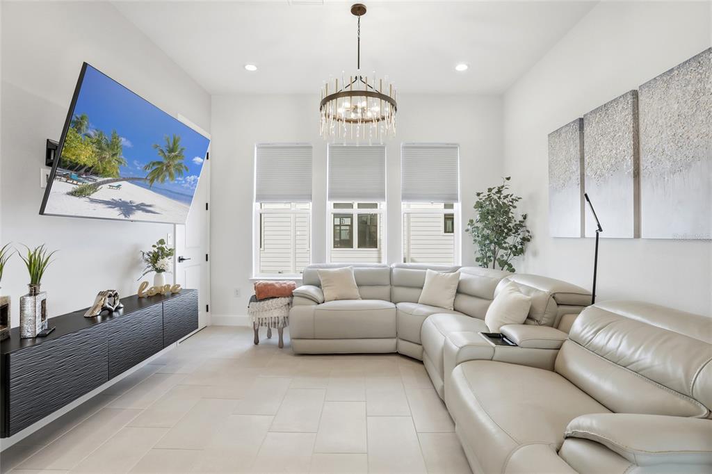 2038 Packing District Way Orlando, FL 32804 - Photo 15 of 39 a living room with furniture a chandelier and a large window