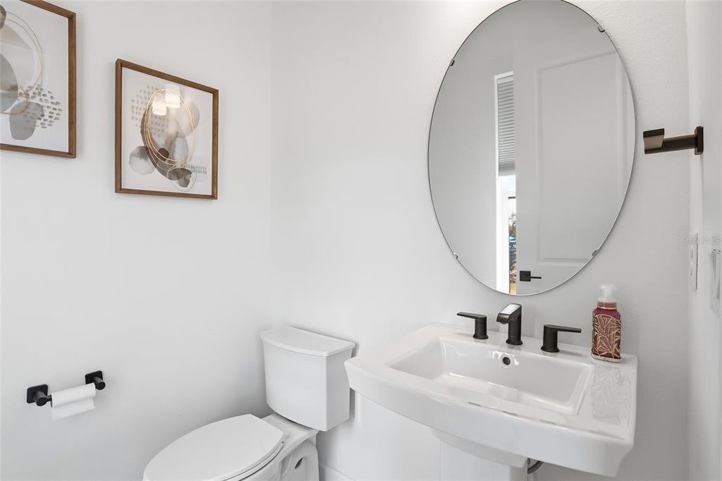 2038 Packing District Way Orlando, FL 32804 - Photo 18 of 39 a bathroom with a toilet sink and mirror