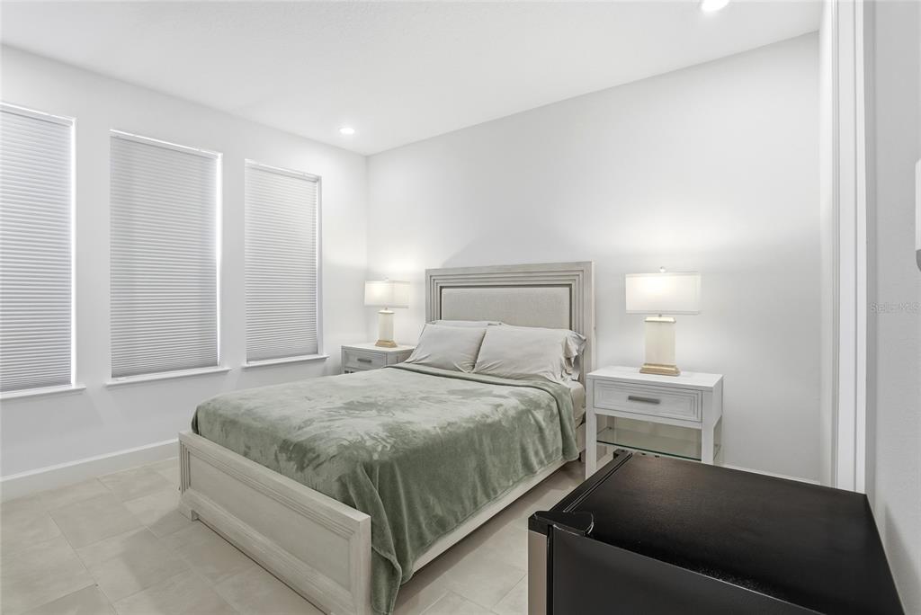 2038 Packing District Way Orlando, FL 32804 - Photo 19 of 39 a bedroom with a bed and a cabinets