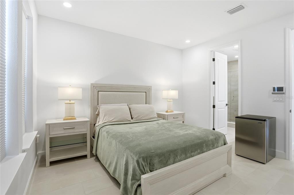 2038 Packing District Way Orlando, FL 32804 - Photo 20 of 39 a bedroom with a bed and a walk in closet