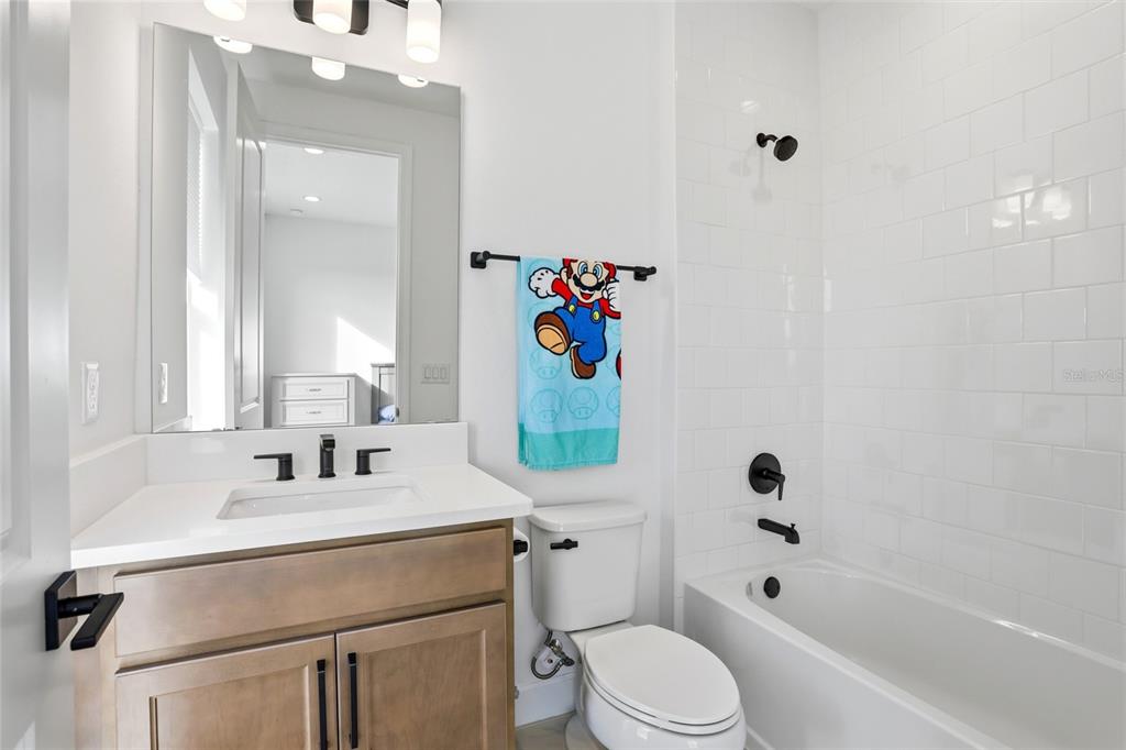 2038 Packing District Way Orlando, FL 32804 - Photo 25 of 39 a bathroom with a sink toilet and shower