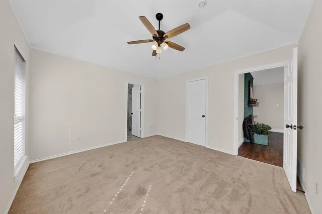 a view of a livingroom with a ceiling fan and a window