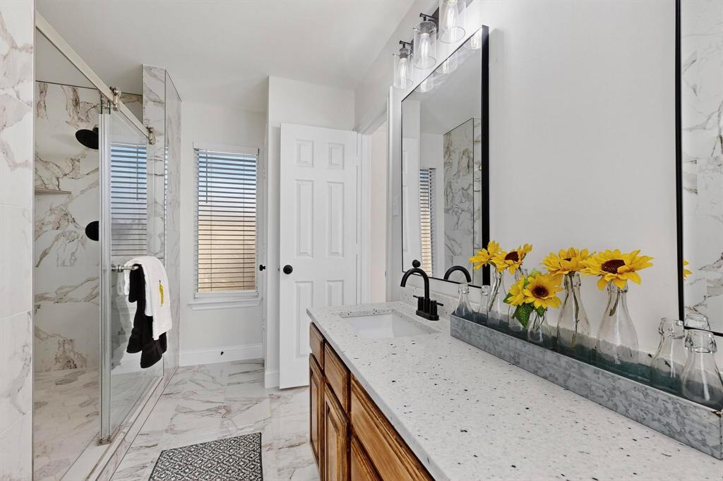 2601 Daisy Lane Rowlett, TX 75089 - Photo 22 of 37 a bathroom with a granite countertop sink and a mirror