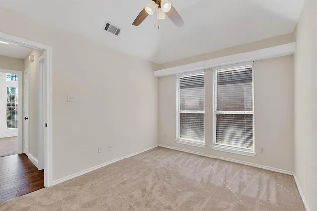 a view of empty room with ceiling fan