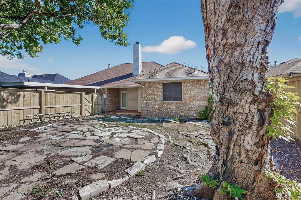 2601 Daisy Lane Rowlett, TX 75089 - Photo 36 of 37 a front view of a house with a yard and garage