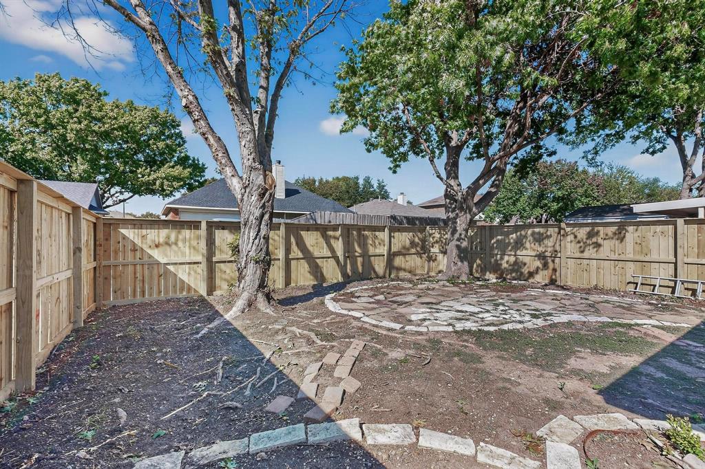 2601 Daisy Lane Rowlett, TX 75089 - Photo 37 of 37 a view of a backyard with large trees and wooden fence