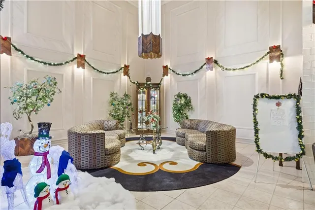 a living room with furniture and flowers