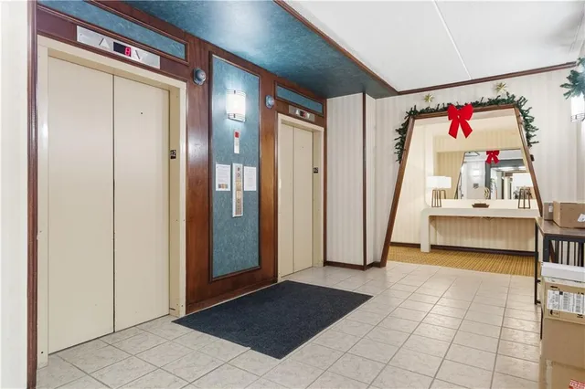 a view of a hallway with closet and cabinet