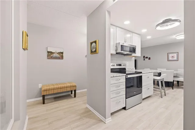 a kitchen with stainless steel appliances kitchen island granite countertop a stove and a sink