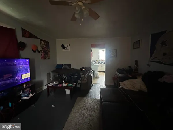 a living room with furniture gym equipment and a lamp