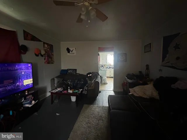 a living room with furniture gym equipment and a lamp