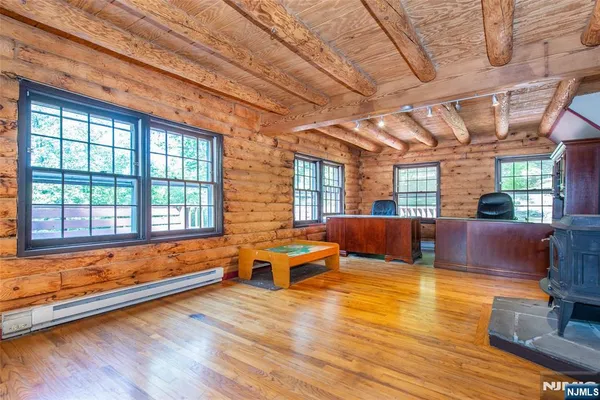 a living room with furniture wooden floor and a large window