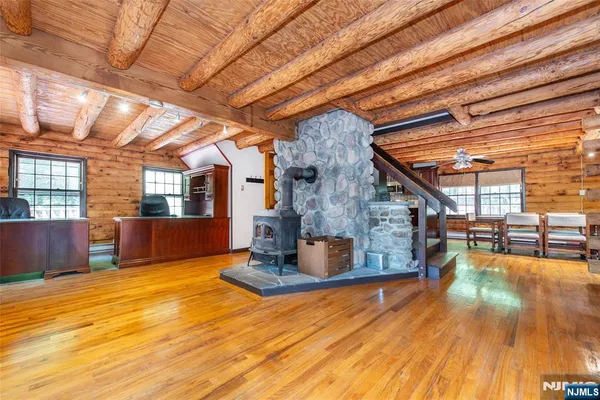 a view of a livingroom with furniture wooden floor and a kitchen