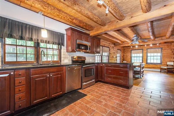 a kitchen with stainless steel appliances granite countertop a stove and cabinets