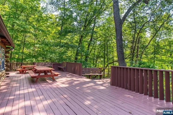 a view of a wooden deck and a backyard