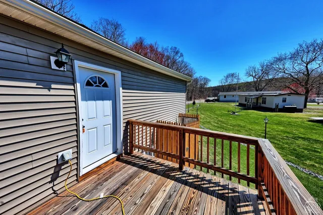 a view of a wooden deck with a yard