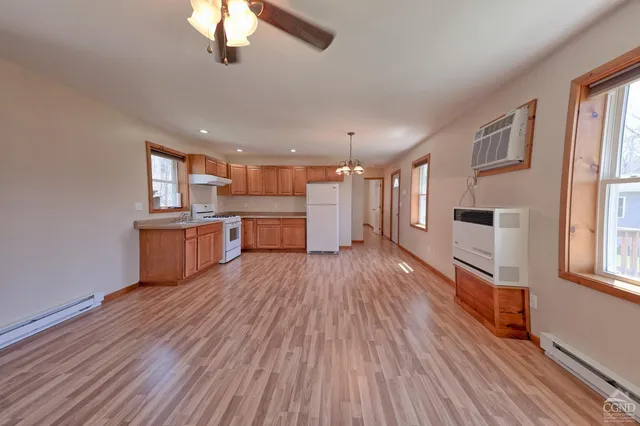 a kitchen with stainless steel appliances granite countertop a stove top oven a sink and dishwasher with wooden floor