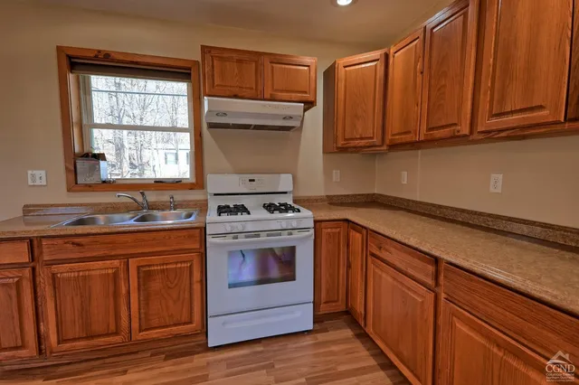 a kitchen with sink cabinets and window