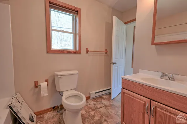 a bathroom with a toilet sink and mirror