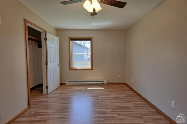 wooden floor in an empty room with a window
