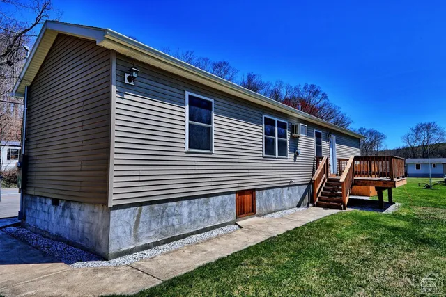 a view of a house with backyard and sitting area