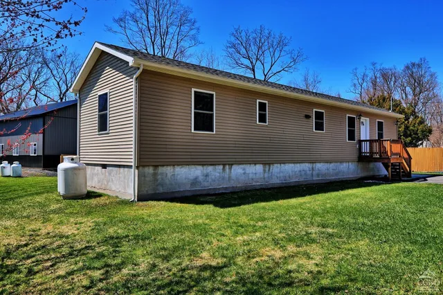 a front view of house with yard and green space