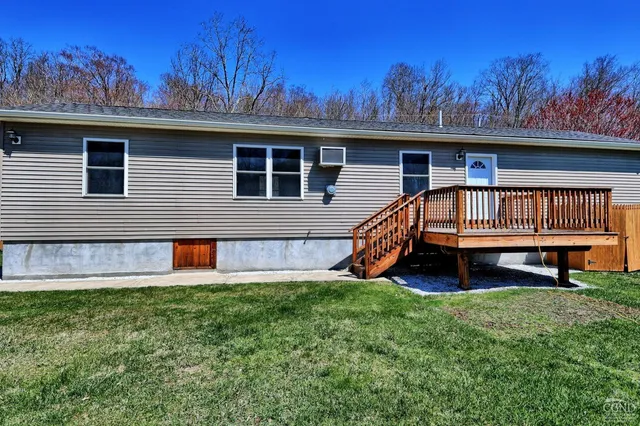 a view of house with a yard