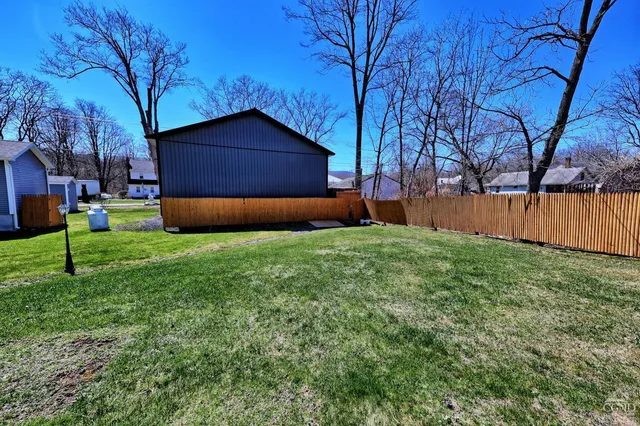 a house view with a sitting space and garden