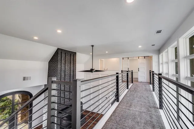 a view of a kitchen with kitchen island a counter space a sink and a stove