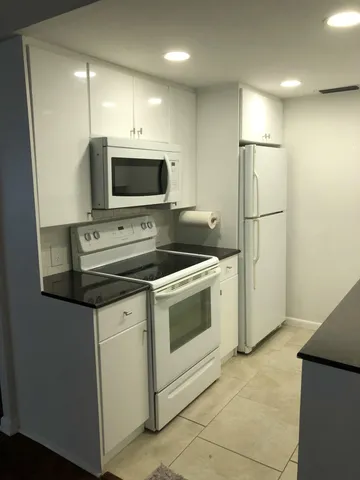 a kitchen with a stove microwave and refrigerator