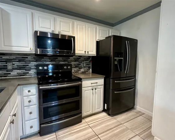 a kitchen with stainless steel appliances and cabinets